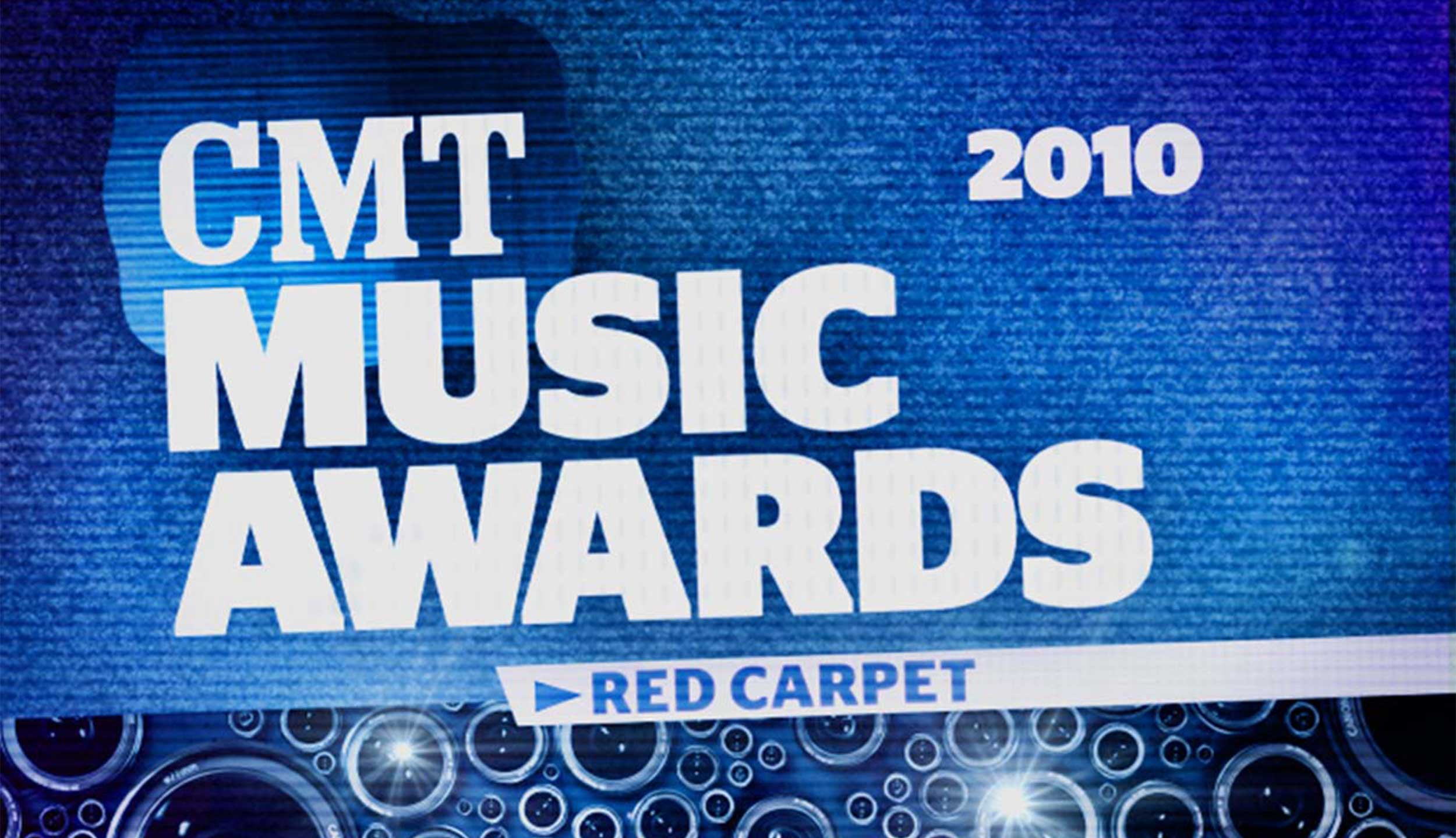 Title Card from Nashville, TN based CMT's 2010 Music Awards intro video designed and animated by Nashville's ST8MNT employing lens flares, camera lens, apertures, stag sans black and a blue black and white color palette