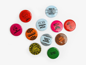 Printed buttons branded for the Raddys given to event guests as part of a table seating identification system including illustrated and typographic designs of Regan era, wax on wax off, to the max, righteous, no problem Alf, mmm donuts, What's your Damage?, Barf Me Out and other 80s catch phrases for the 51st Nashville Addy Awards in Tennessee