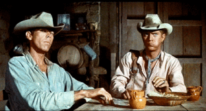 Animated Gif of Steve McQueen sitting at a table in a western setting for ST8MNT Blog post
