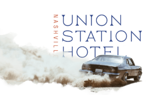 Vintage car kicking up dust in front of the Union Station Logo wordmark.