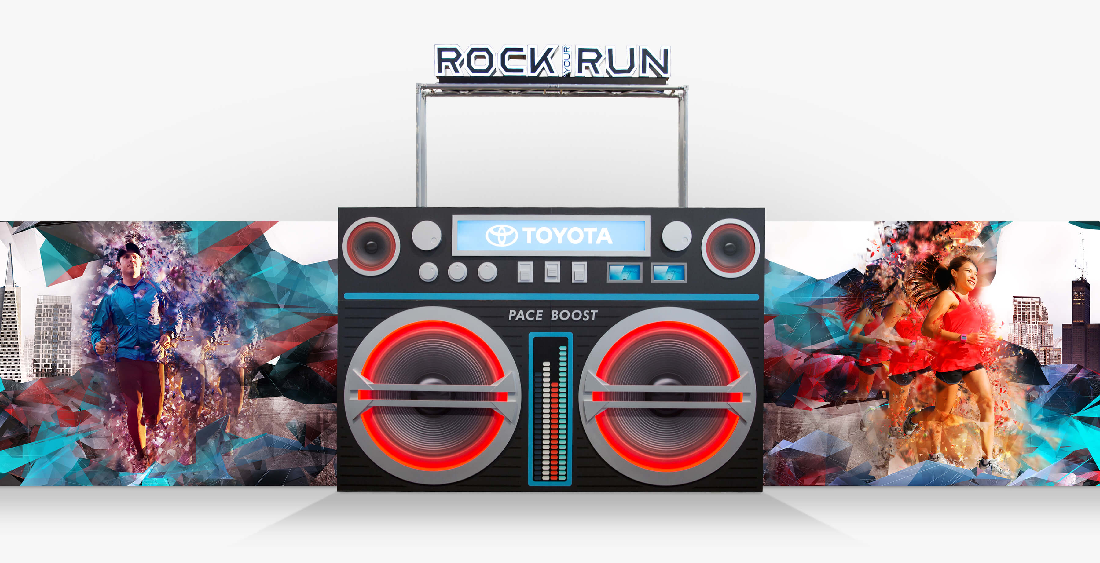 Toyota Rock Your Run back wall middle panel featuring a giant boom box, a male and female runner, dynamic geometric fragments, and city scape.