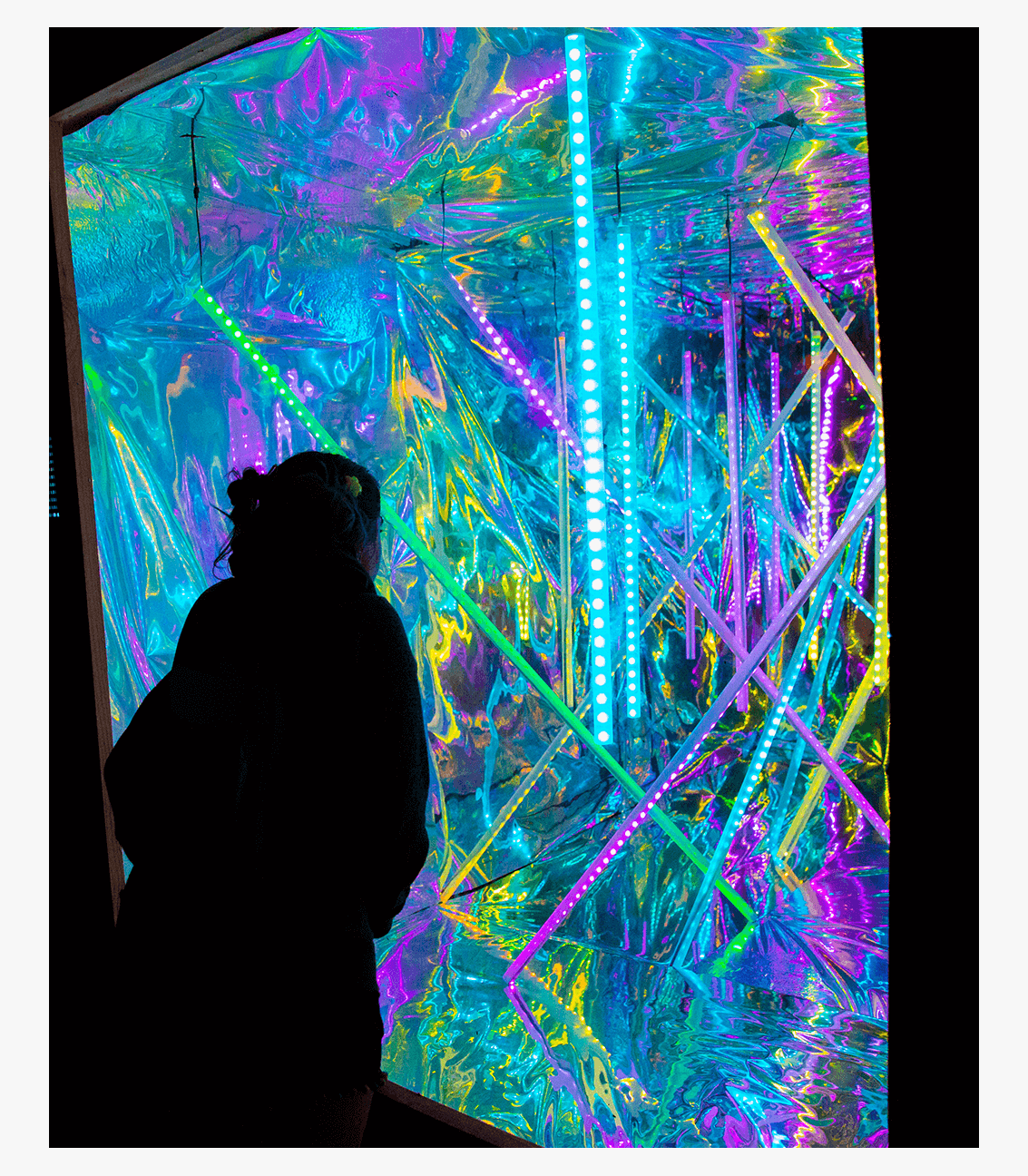 Photo of girl at the Hanging LED Tube light container art installation at Bonnaroo Music & Arts Festival in Manchester, Tennessee