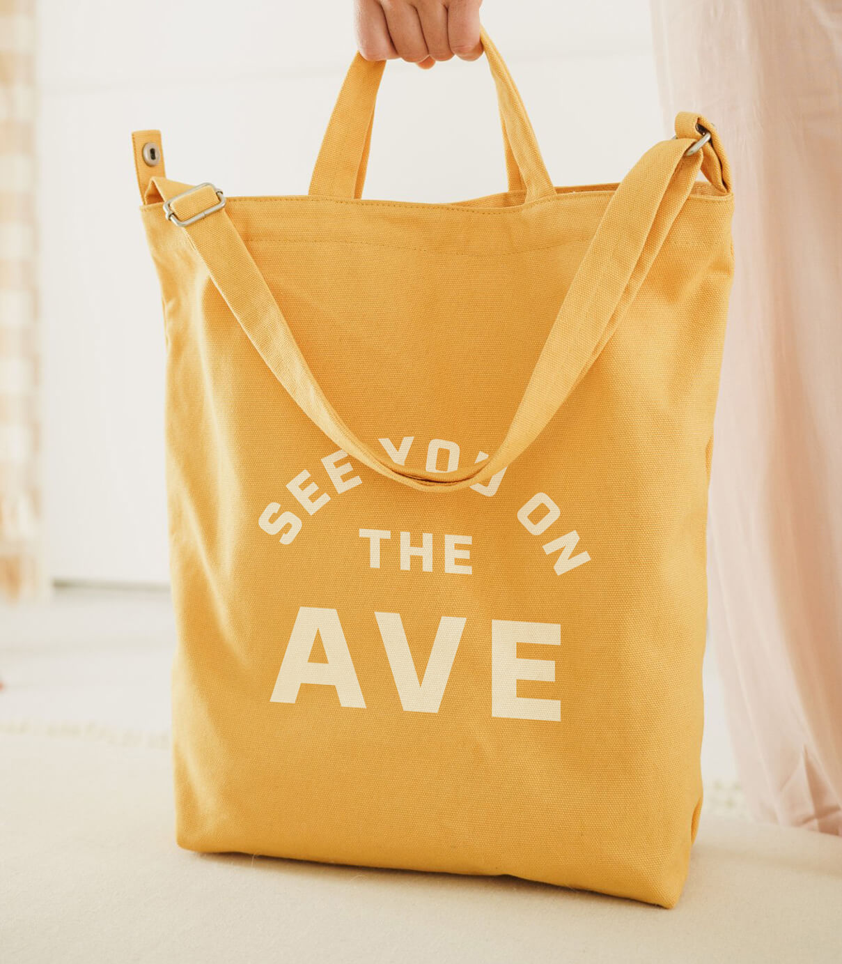 yellow canvas tote bag with see you on the ave typographic lockup design