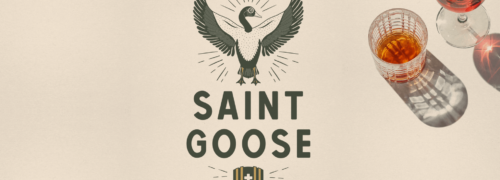 Saint Goose logo wine + whiskey + wisdom with glass of whiskey and wine