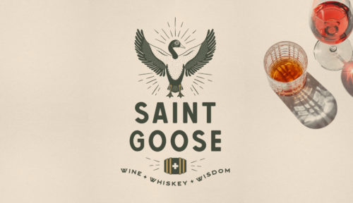 Saint Goose logo wine + whiskey + wisdom with glass of whiskey and wine