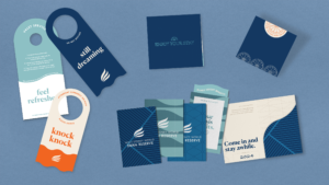 Flatlay with mockups of DSR guest experience collateral including door hangs and key card folders