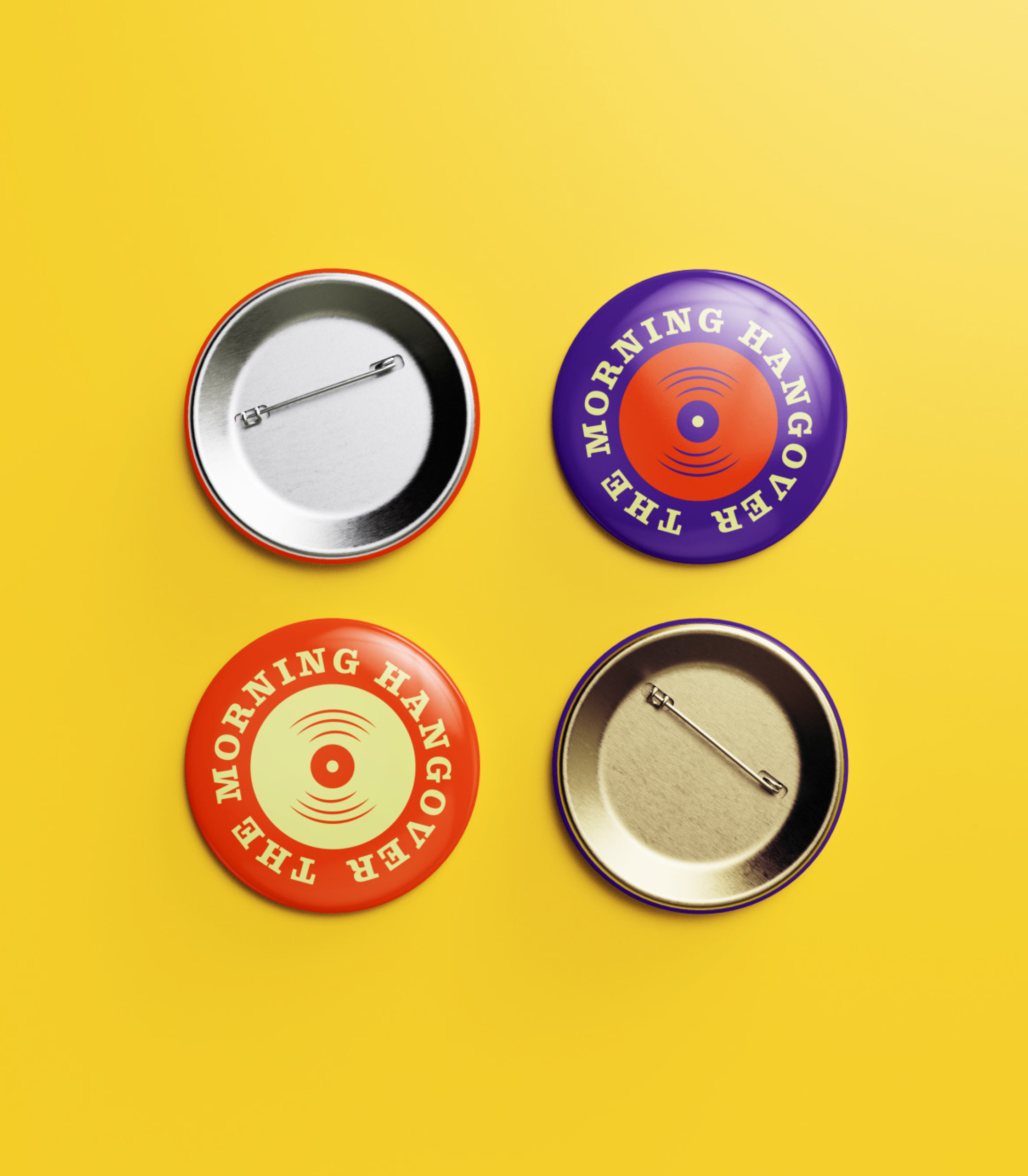 Small pins with The Morning Hangover record logo on them. One pin is purple with an orange record and the other is orange with a melon record..