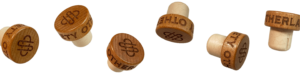 a row of floating wooden bottle caps with engraved Otherland society text and OS monogram logo