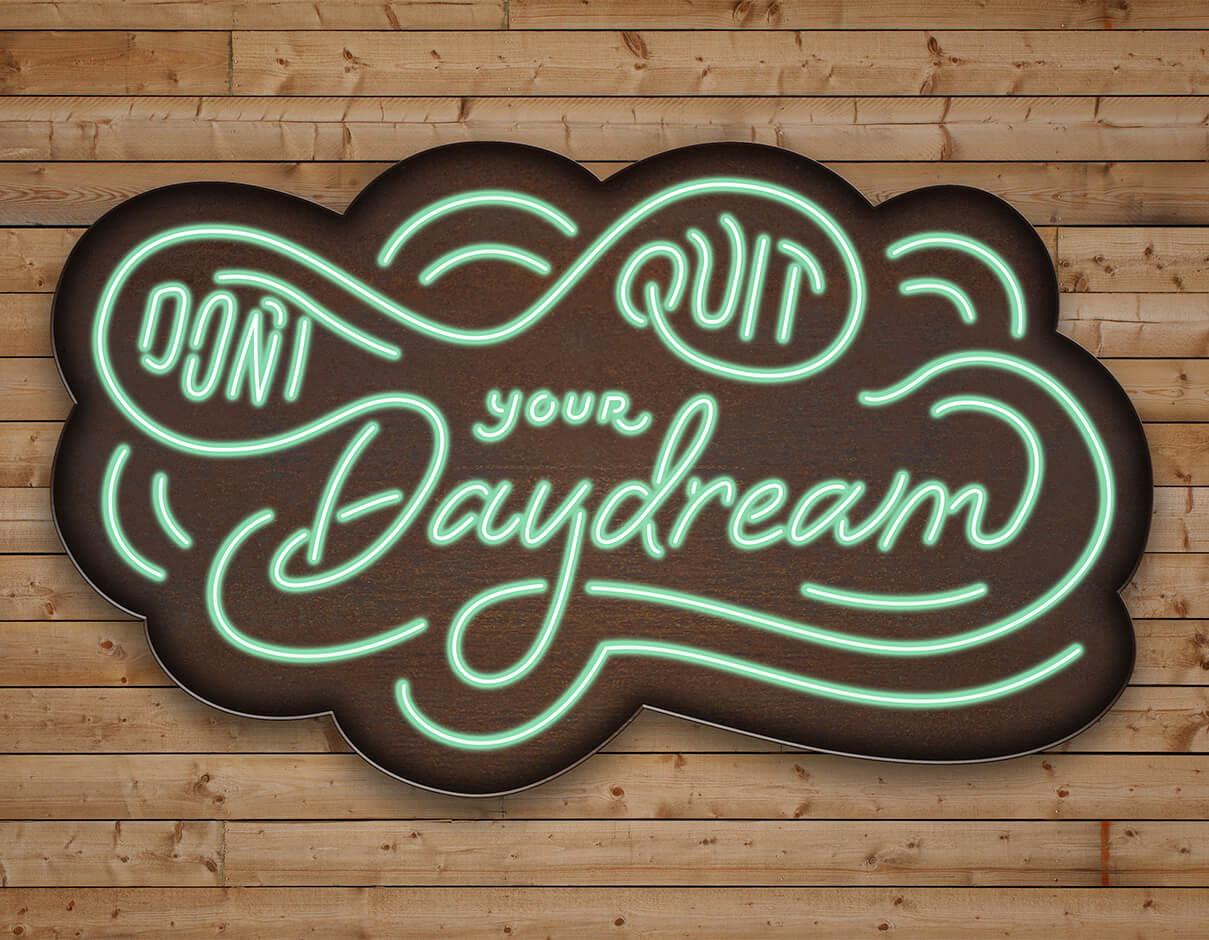 Don't quit your daydream neon and metal signage on wooden background