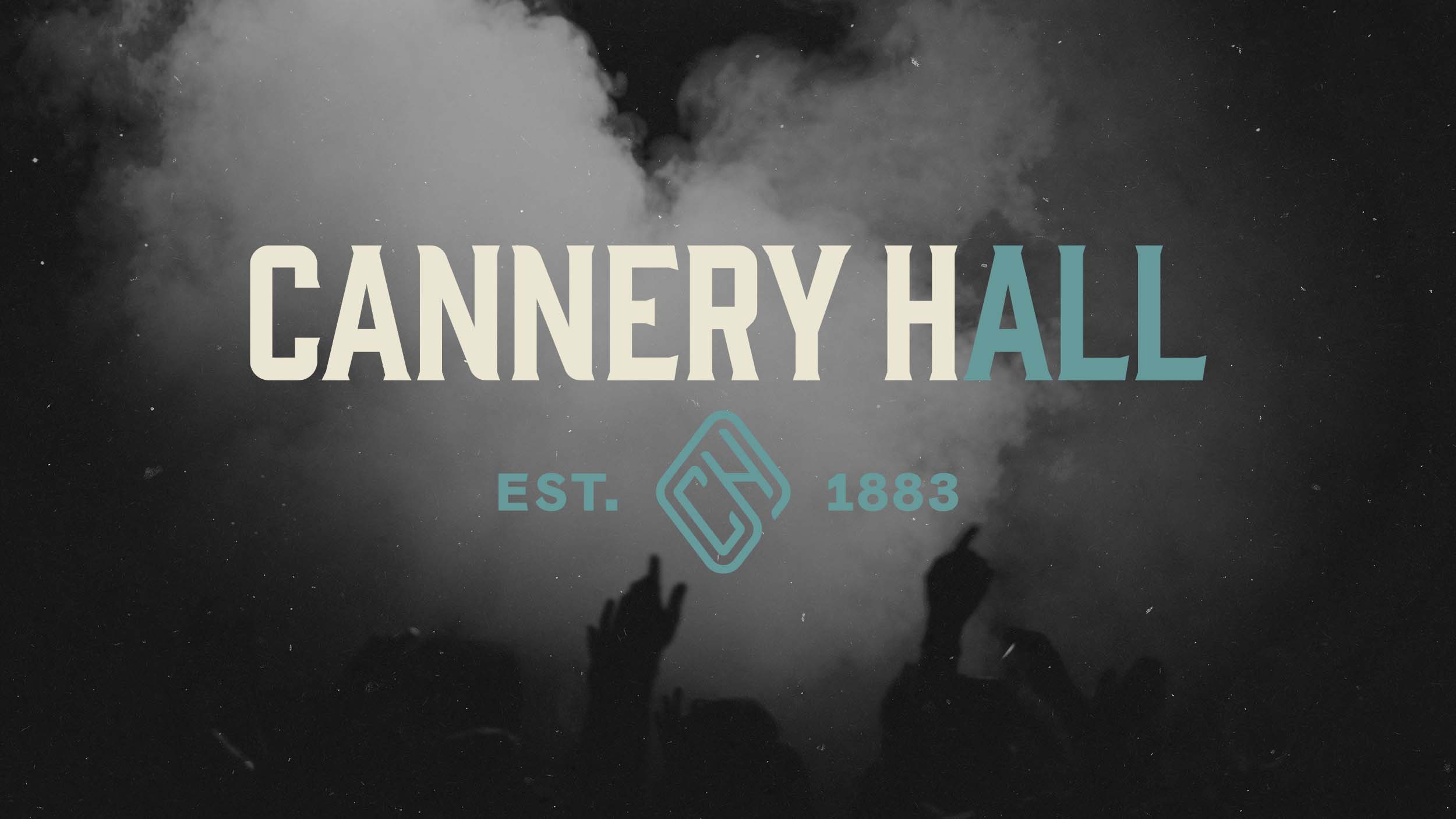 Cannery Hall horizontal logo over a smokey concert crowd.