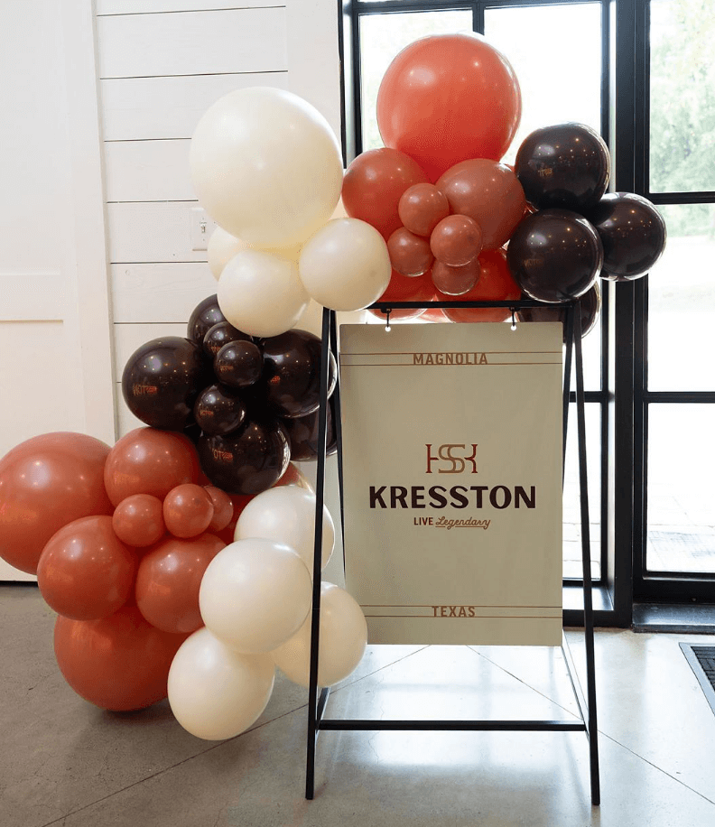 Image of branded sign with balloon decor from the name reveal event