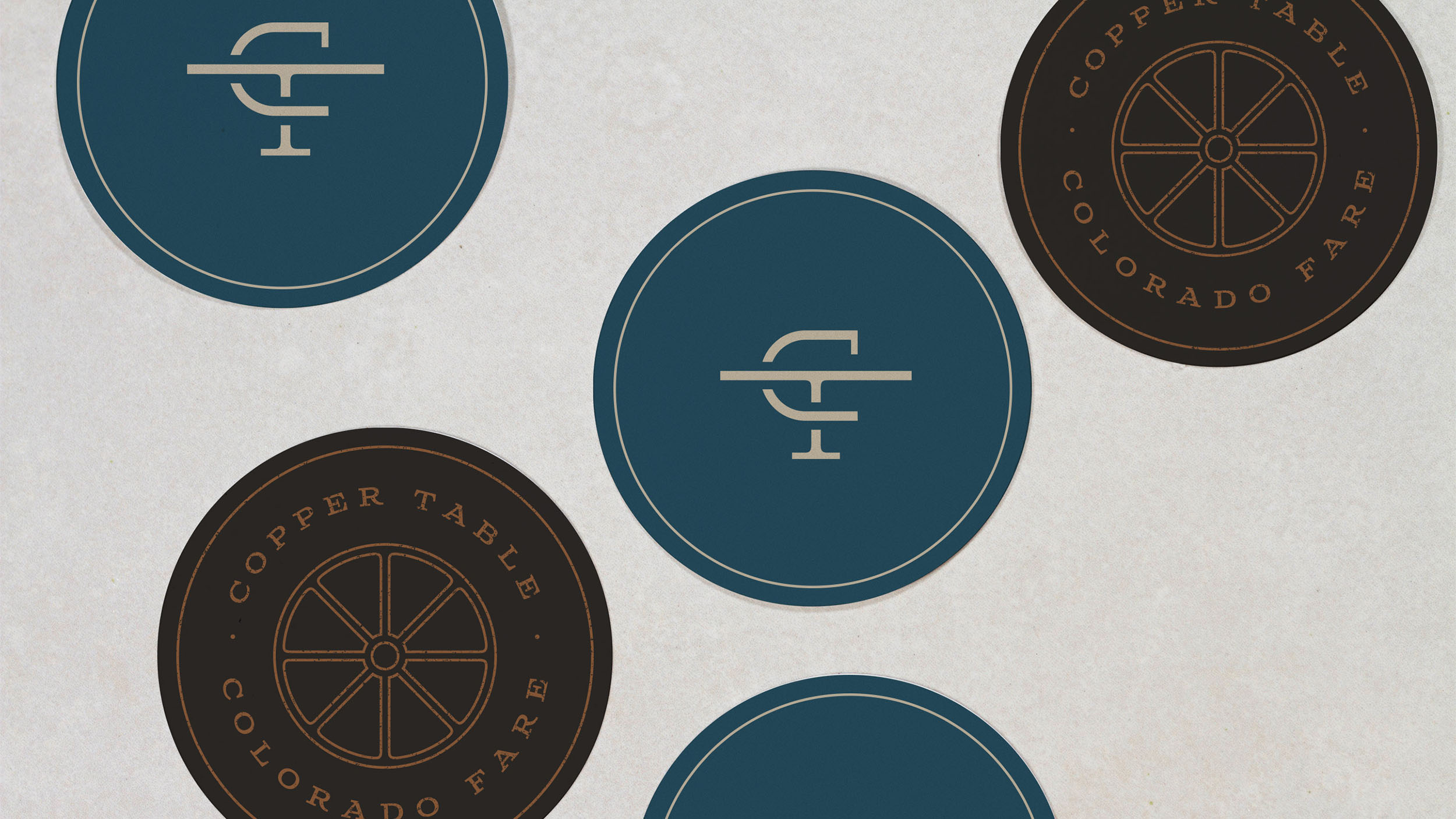 Copper Table brand identity monogram and icons on coasters designed by ST8MNT