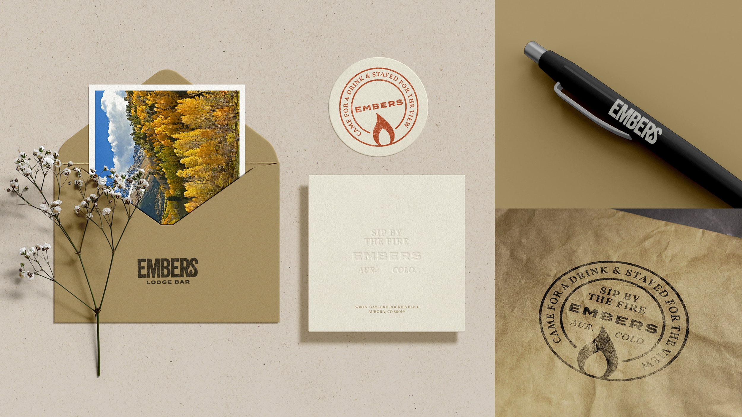 The Embers branding shown on an envelope, coaster, notepad, pen, and paper bag.