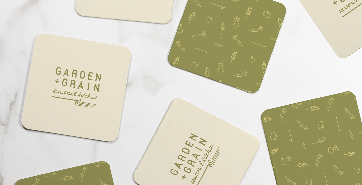 Flat lay of G+G branded coasters with logo and pattern