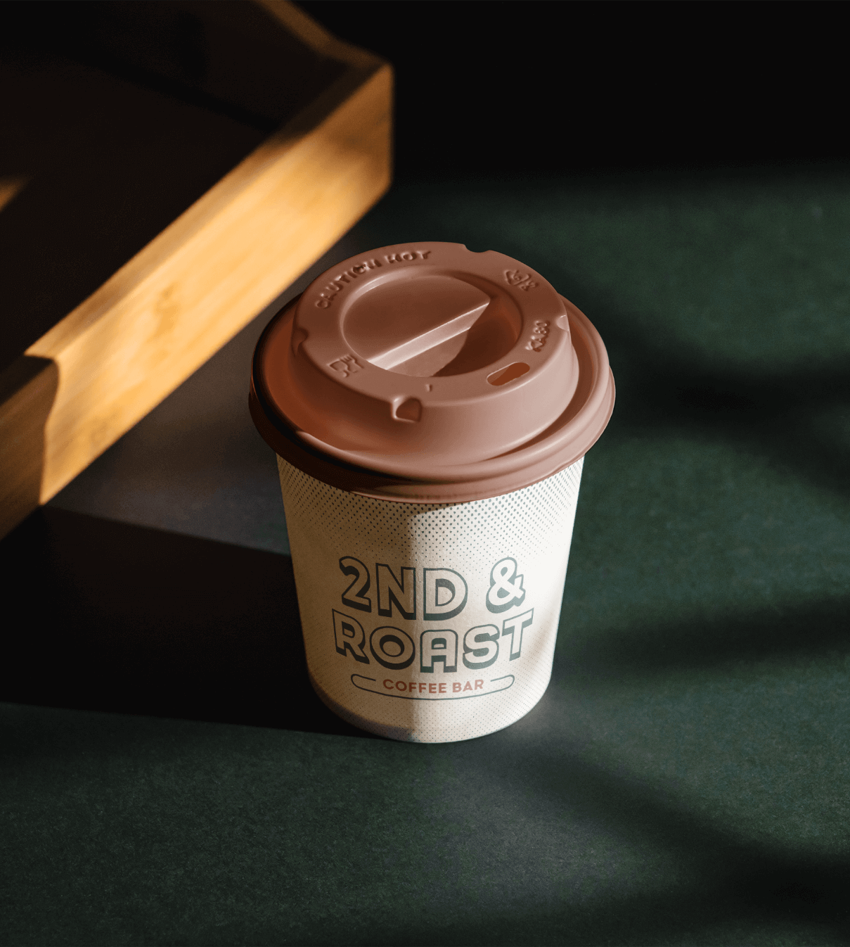 Mockup of to-go coffee with graphic elements from 2nd & Roast identity system created by ST8MNT as part of branding project for W Hotel in Downtown Austin