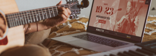 Americana Music Association homepage design displayed on a songwriter's laptop