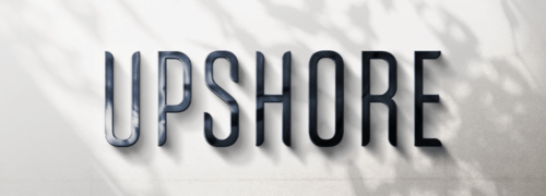 Metal signage with leafy shadow overlays of Upshore wordmark