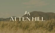 Atten Hill logo designed by St8mnt place over top of an image of the Texas hill country.