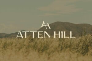 Atten Hill community logo designed by St8mnt place over top of an image of the Texas hill country.