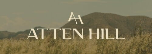 Atten Hill community logo designed by St8mnt place over top of an image of the Texas hill country.