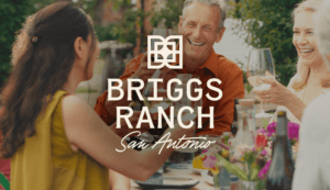 Briggs Ranch San Antonio logo lockup on lifestyle imagery of friends enjoying dinner